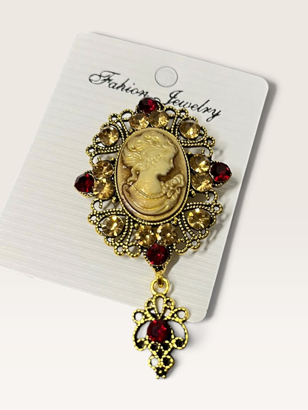 Vintage-Inspired Gold Cameo Brooch with Red and Champagne Stones